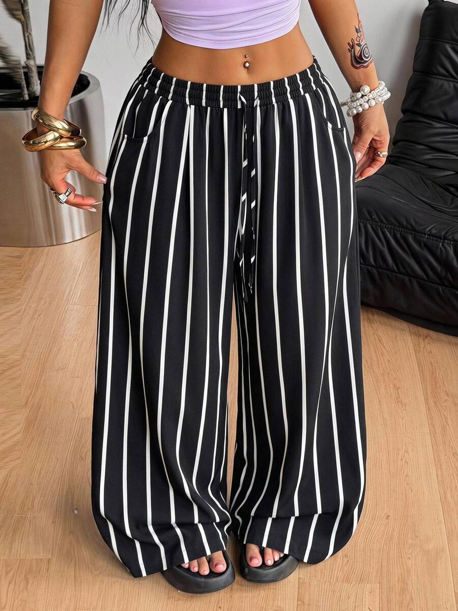 Plus size women's striped loose straight leg cropped pants with pleated detailing and side pockets