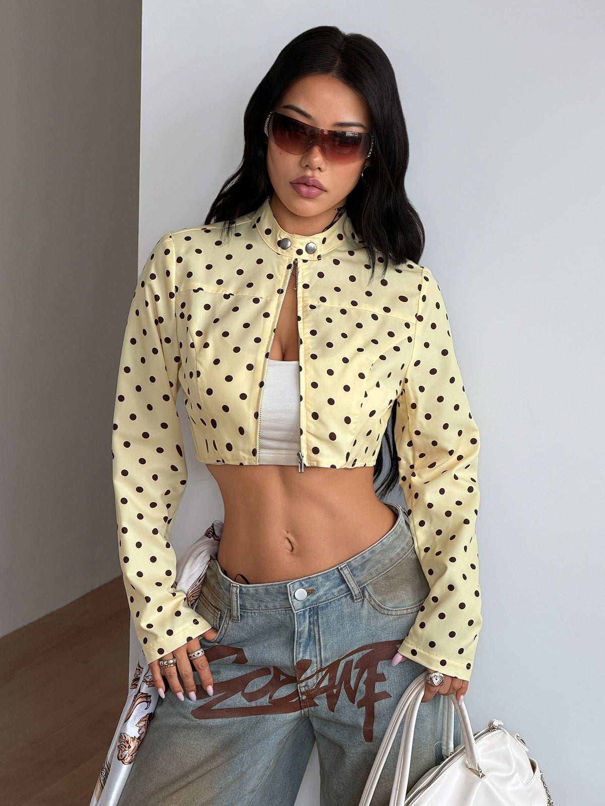 Women's metallic grey cropped faux leather jacket featuring a stand collar and asymmetrical zip front closure.
