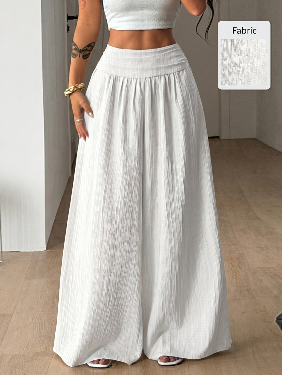 Women's plus size high-waist pleated wide leg pants in textured woven fabric with pockets