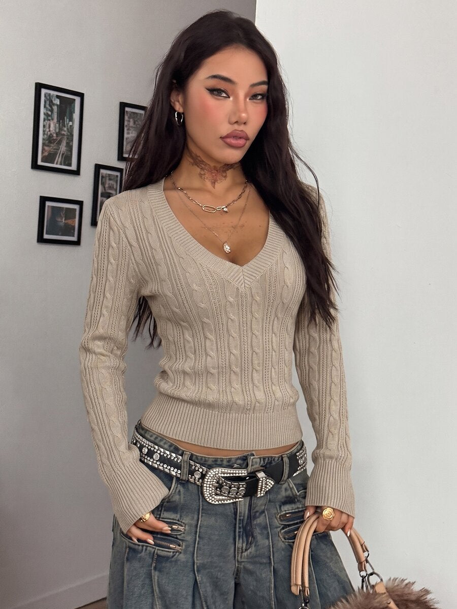 Women's slim fit cable-knit long sleeve sweater featuring a V-neckline and ribbed knit details.