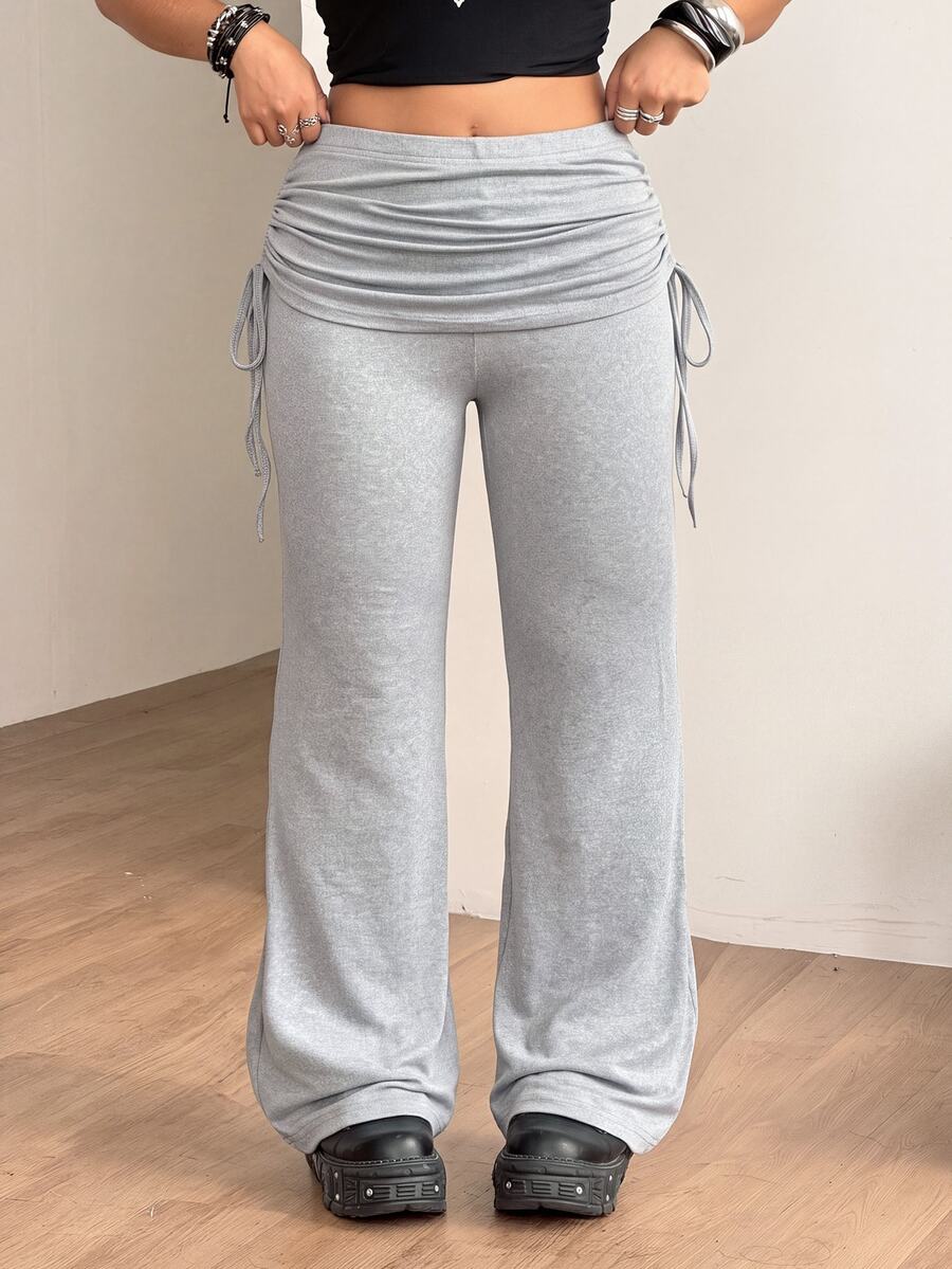 Women's striped flare leg pants featuring a mid-rise waist, slim fit thigh, and ruched side drawstring detail in stretch knit fabric.