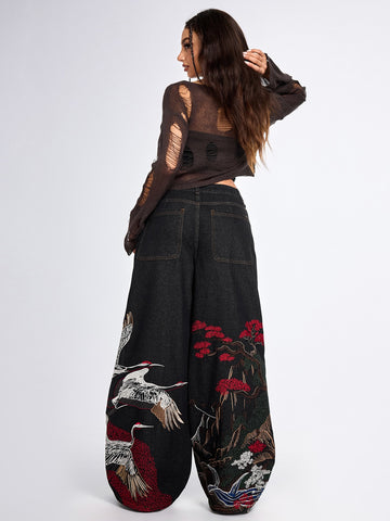 Women's black loose wide leg jeans with detailed crane and landscape embroidery, zipper fly, and ultra low waist.