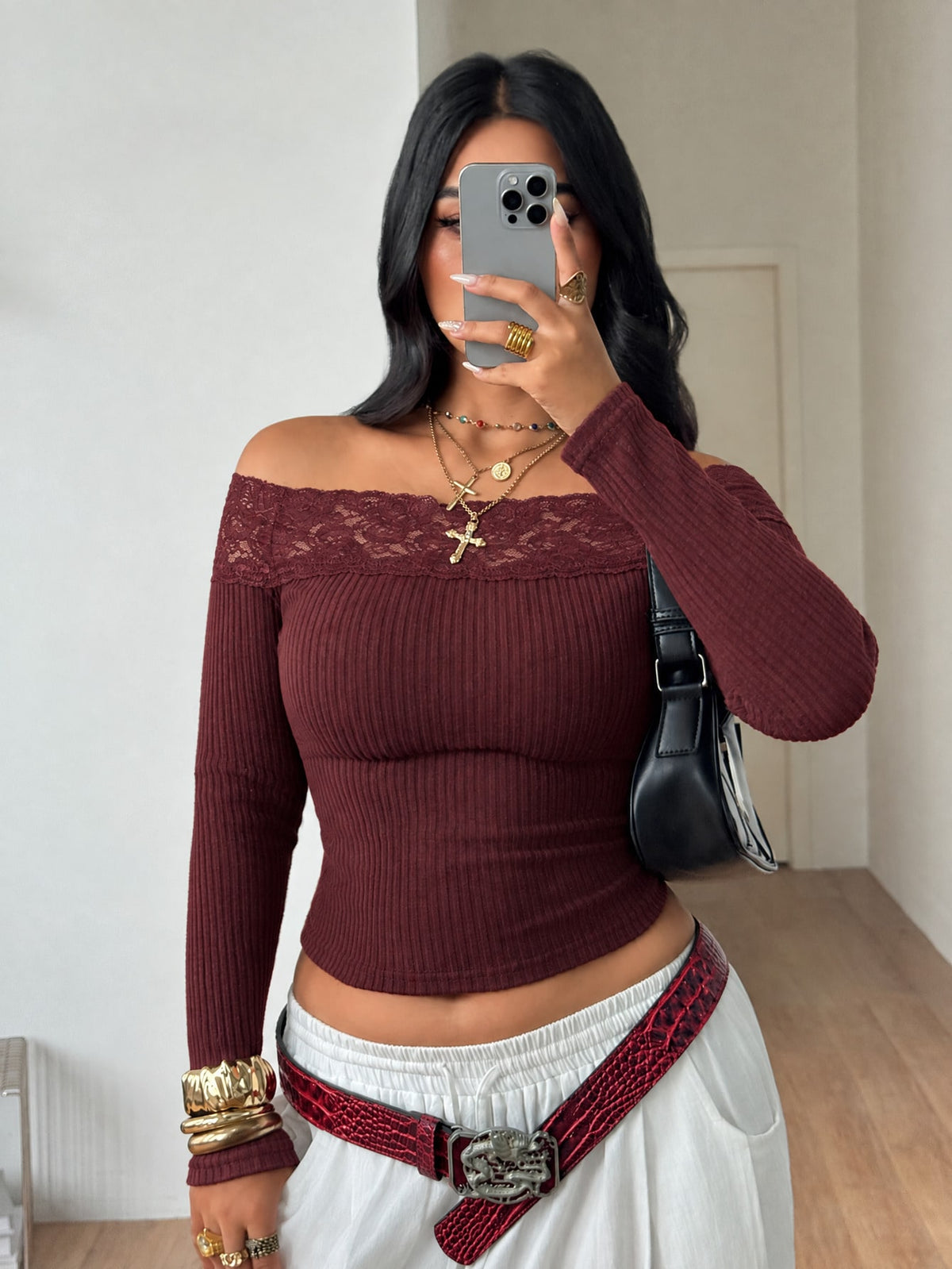 Women's striped off the shoulder long-sleeve top with contrast lace trim and ribbed knit texture.