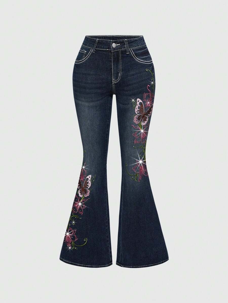 Women's blue ultra low waist flare jeans with butterfly vine embroidery and rhinestone detailing on stretch denim.