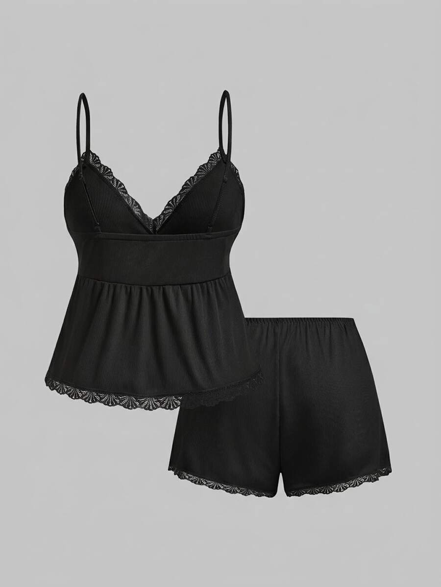 Two-piece ribbed pajama set featuring a lace-trimmed crop camisole top with spaghetti straps and matching shorts.