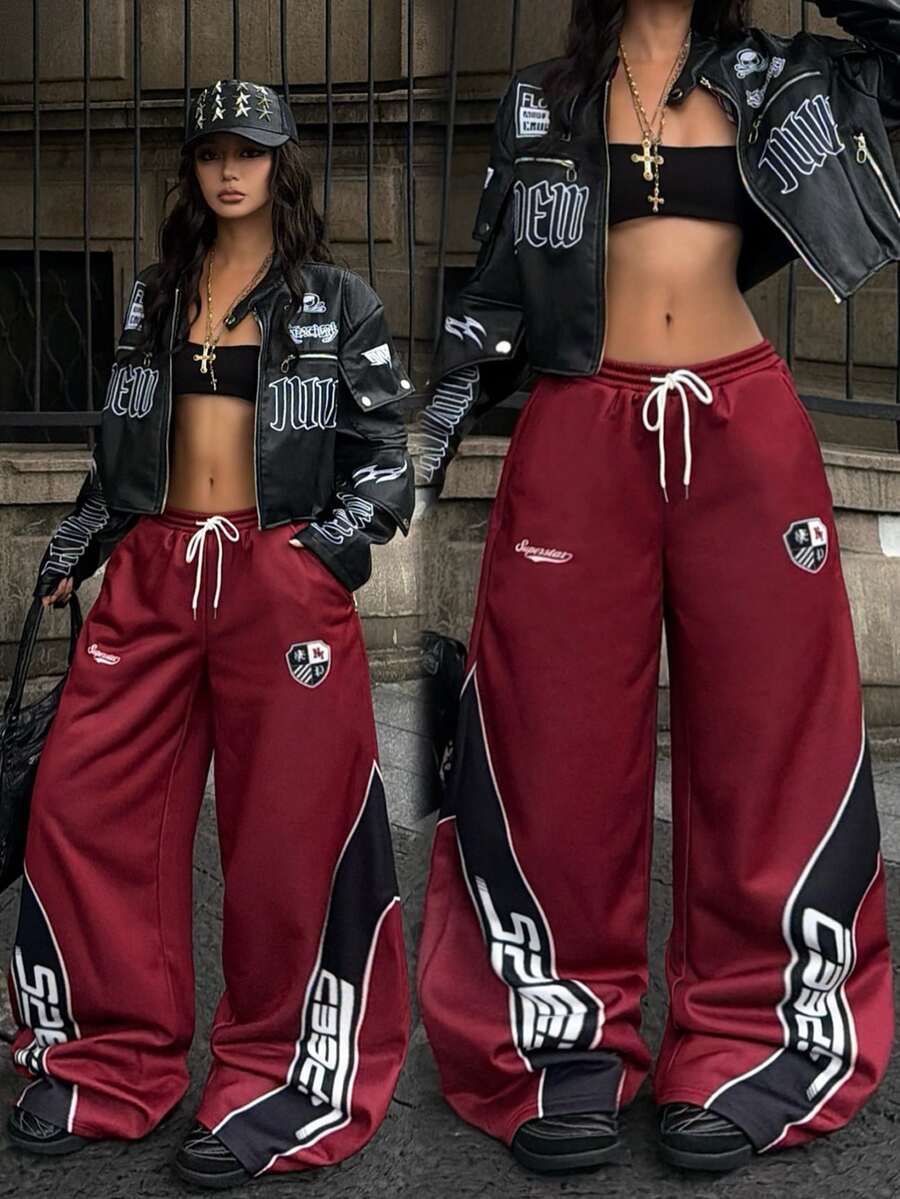 Women's loose fit wide leg graphic sweatpants in light grey with an elastic drawstring waistband