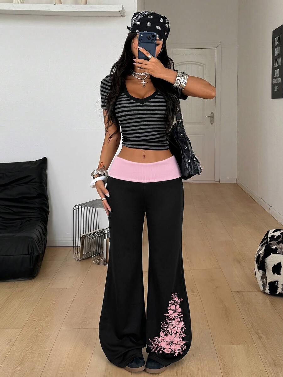 Women's black low waist wide leg flare sweatpants with rib-knit texture and contrast binding details.