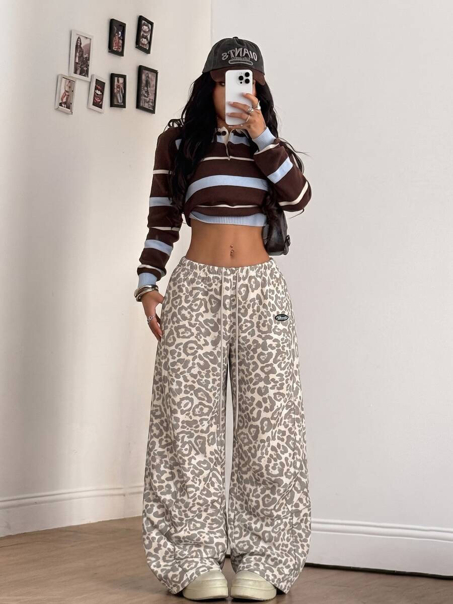 Women's black baggy jogger pants with an adjustable drawstring waist and colorblock polka dot geometric pattern.