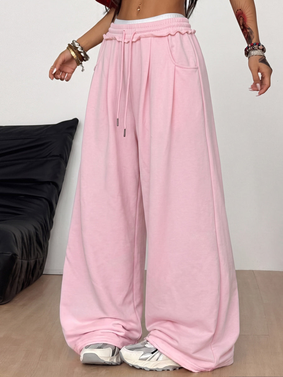 Women's casual straight leg baggy lounge pants in light grey with an adjustable drawstring waist and side pockets.