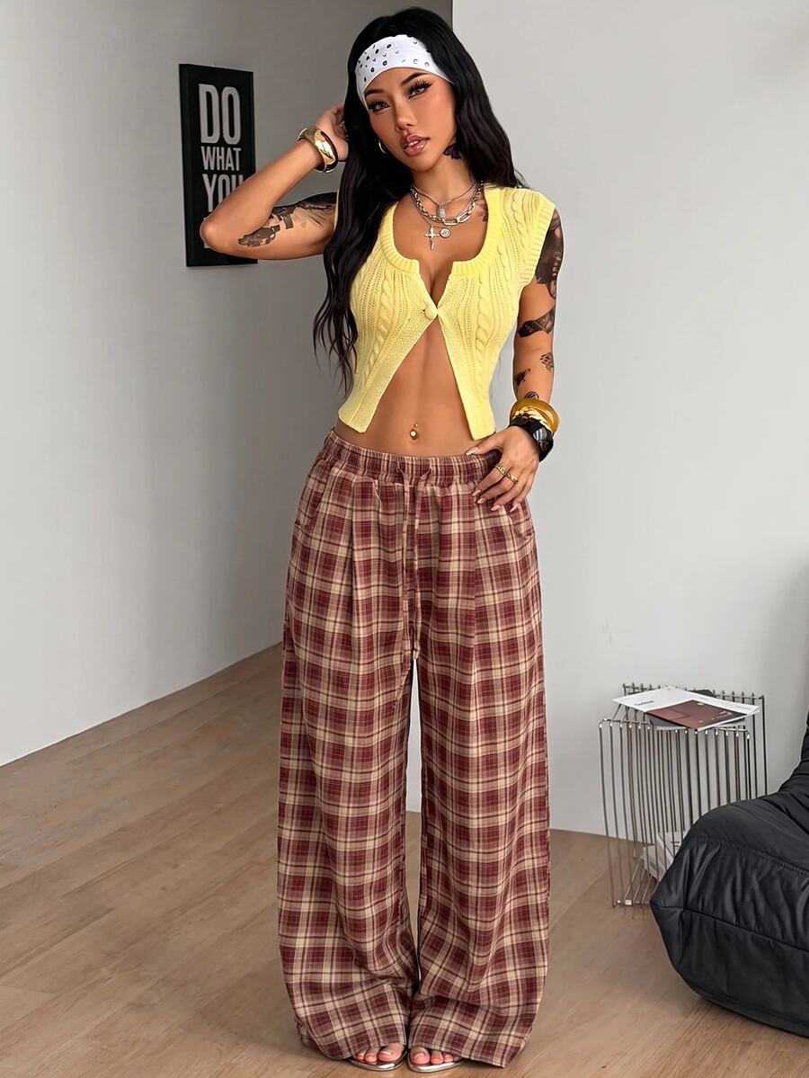 Women's loose fit brown and tan plaid wide leg pants featuring an elastic drawstring waist and side pockets.