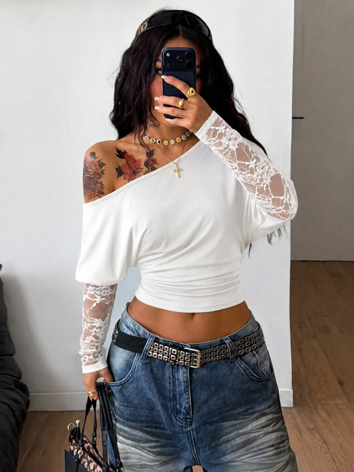 Women's black long sleeve t-shirt featuring delicate contrast lace details and a boat neckline in a knitted stretch fabric.
