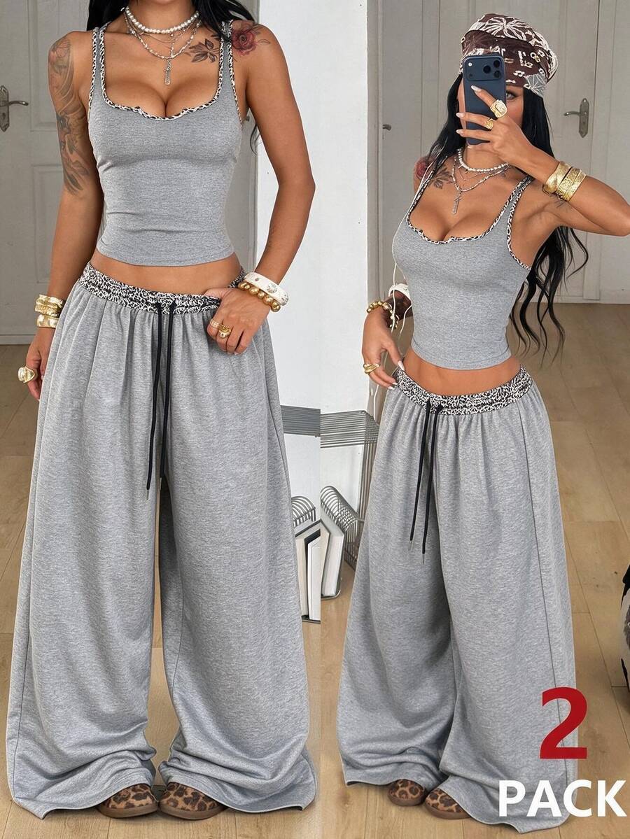 Women's two-piece casual outfit featuring a slim-fit camisole tank top with ruffle trim and button front paired with high-waisted wide leg pants.