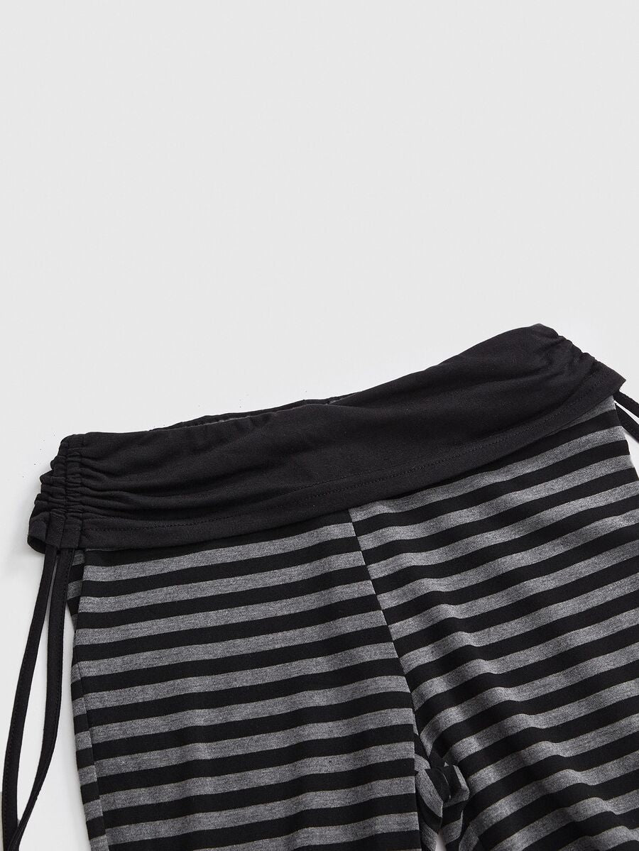 Women's low waist flare leg pants featuring an elastic drawstring waistband and ruched detail in knitted fabric.