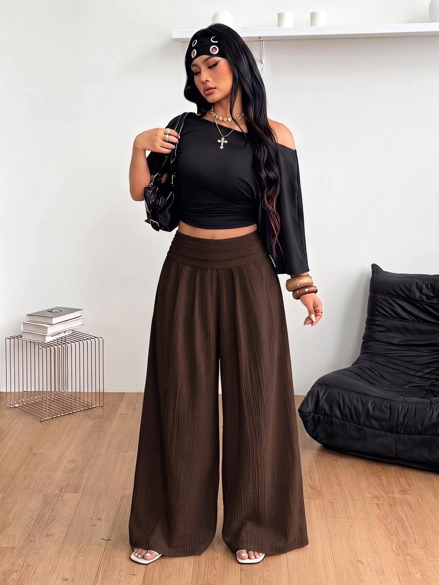 Women's plus size high-waist pleated wide leg pants in textured woven fabric with pockets