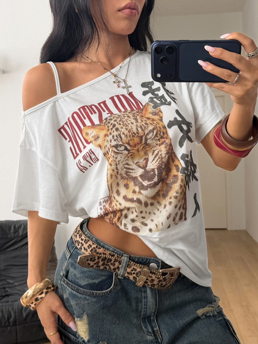 Women's white short sleeve t-shirt featuring an asymmetrical neckline with cut-out detail and a colorful animal tiger print.