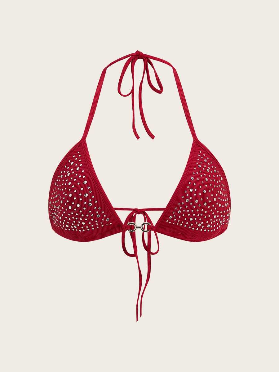 Women's slim fit halter crop top featuring a backless cut with knot and rhinestone accents.