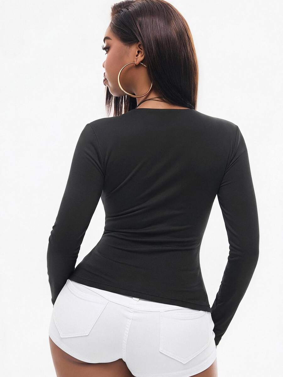 Women's fitted long sleeve rib-knit top featuring a deep V-neckline with delicate contrast lace detailing.