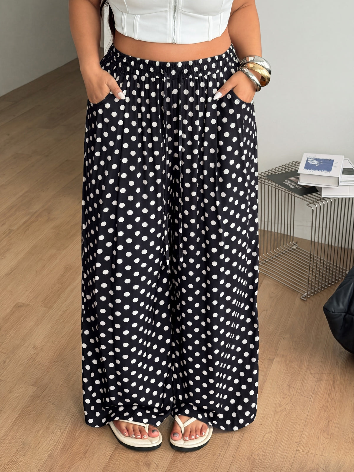 Plus size women's striped loose straight leg cropped pants with pleated detailing and side pockets