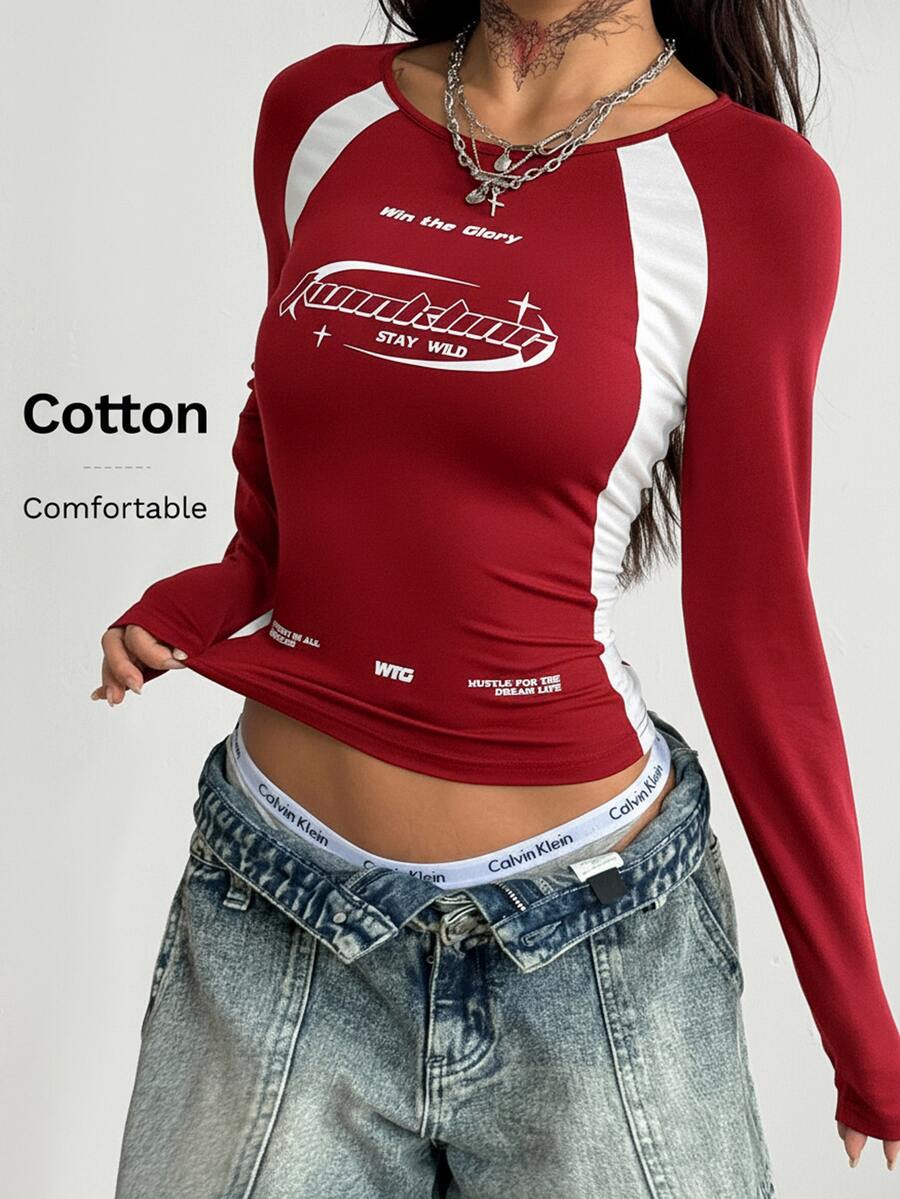 Women's slim fit long sleeve raglan t-shirt with collegiate letter graphic print, round neck, and contrast binding.
