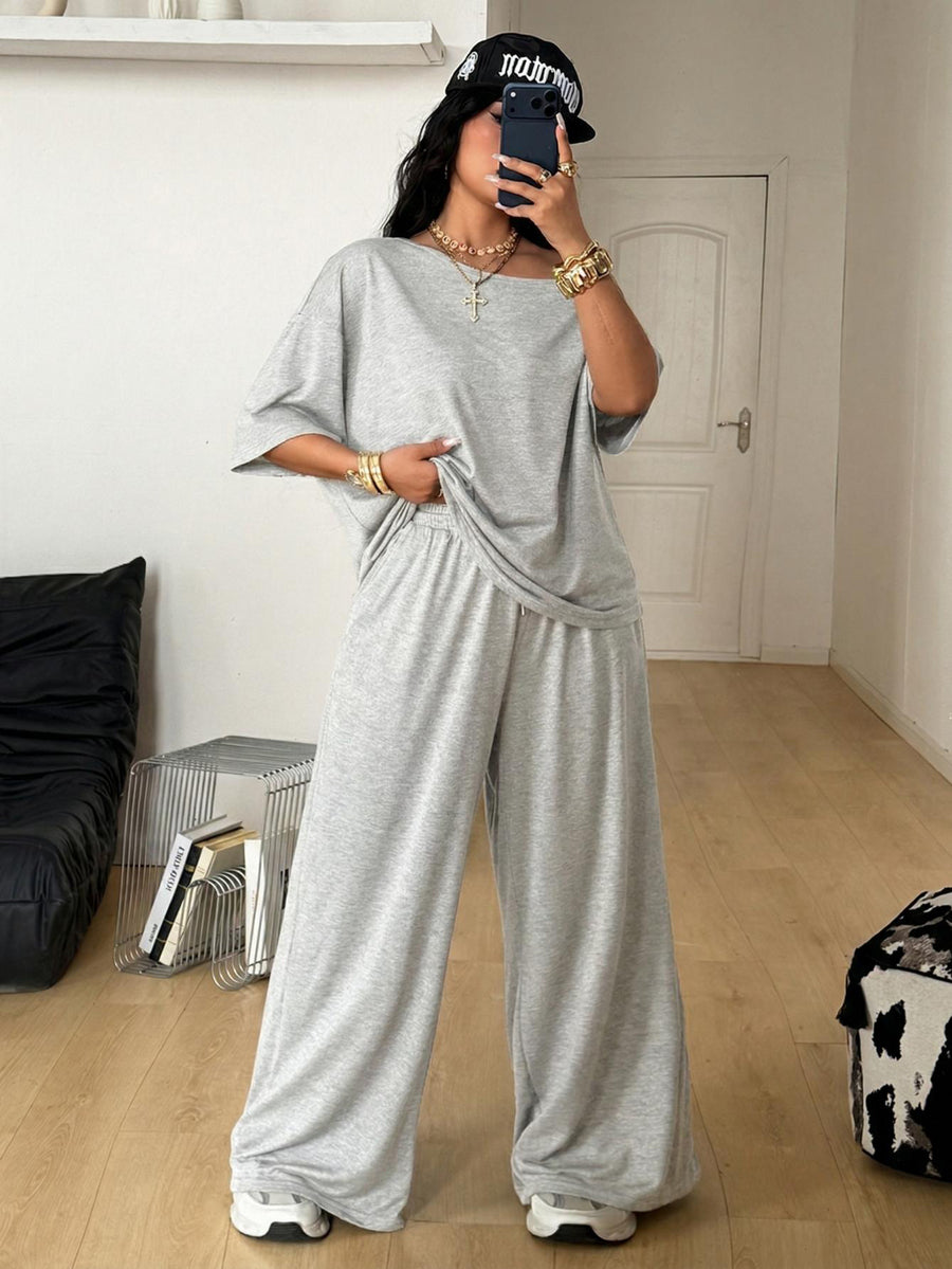 Women's two-piece lounge set featuring a loose drop shoulder asymmetrical neck short sleeve t-shirt and wide-leg knit pants with pockets.