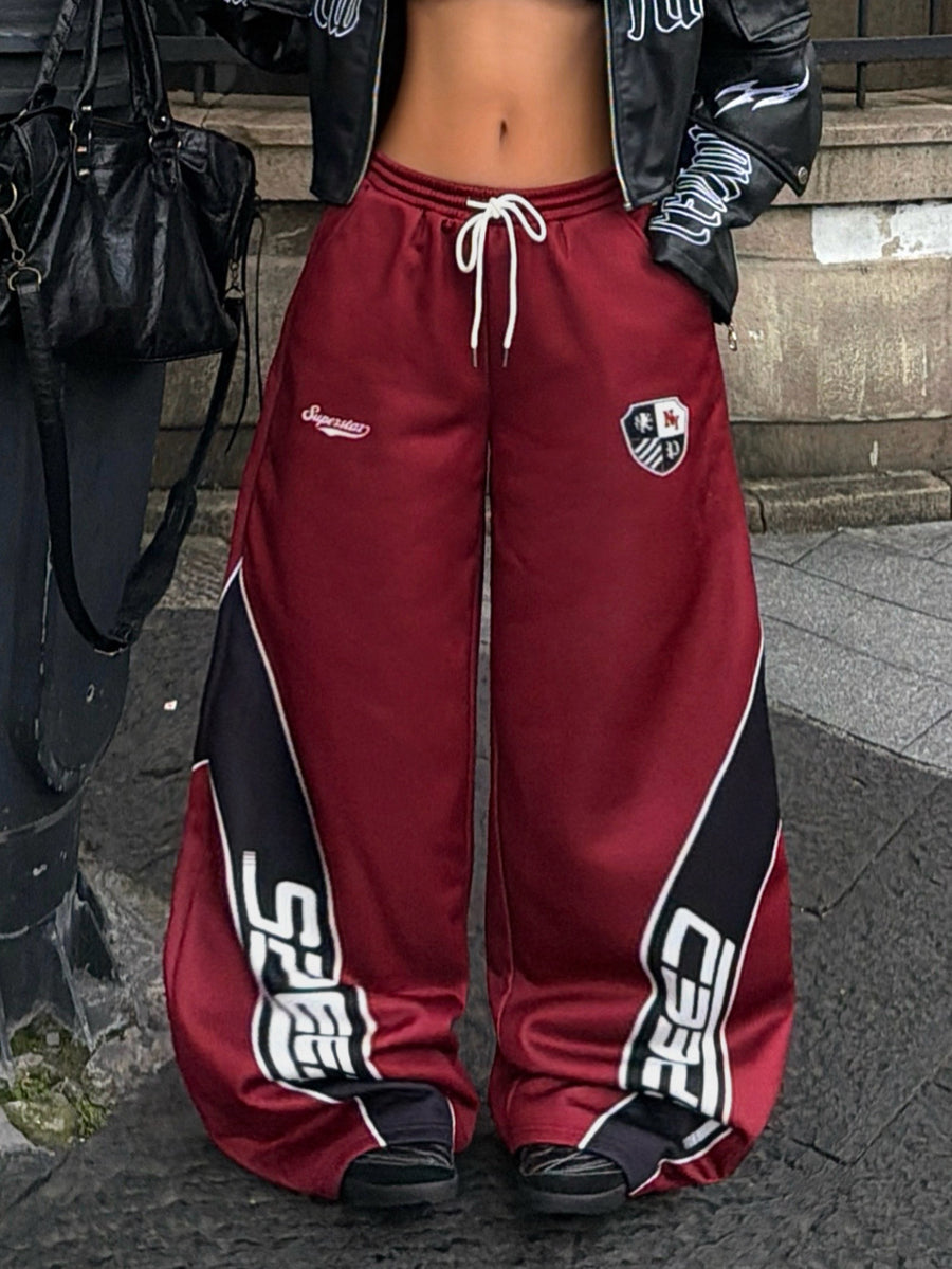Women's loose fit wide leg graphic sweatpants in light grey with an elastic drawstring waistband