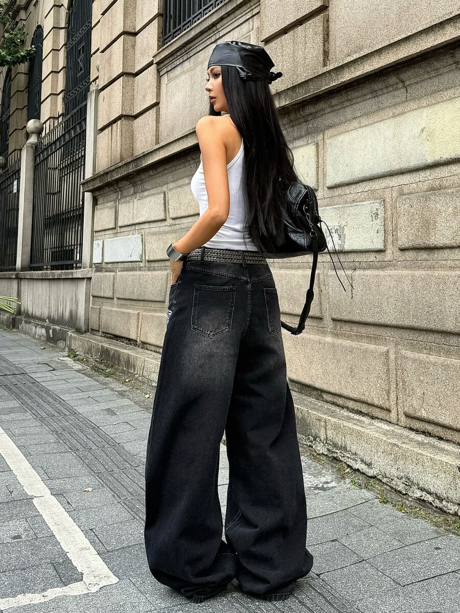 Front view of women's loose wide leg denim jeans featuring a mid waist, classic front pockets, and a zipper fly closure.