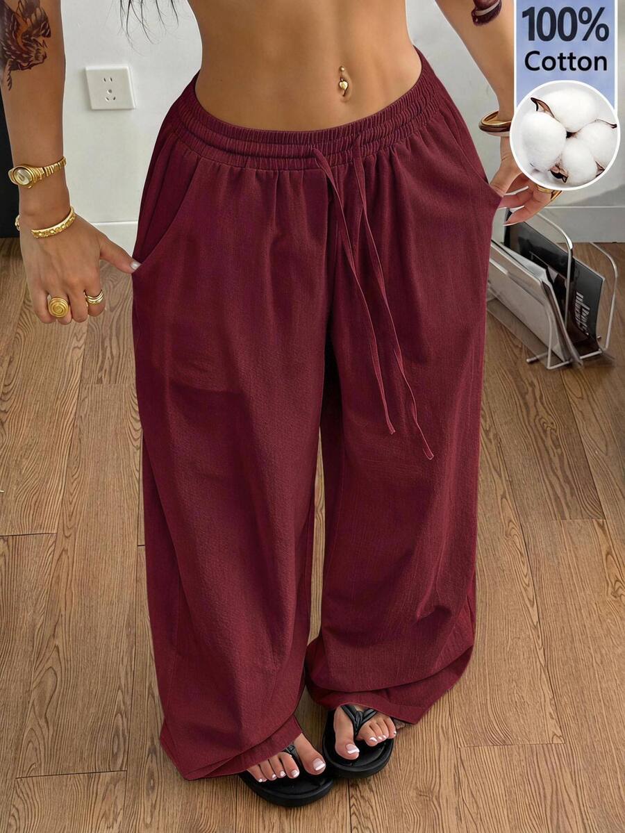 Plus size women's striped loose straight leg cropped pants with pleated detailing and side pockets