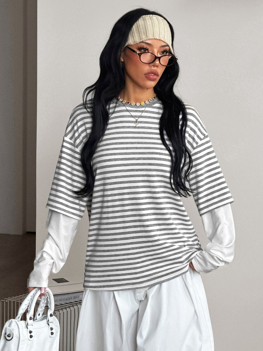 Women's casual graphic long sleeve t-shirt with a round neck, drop shoulder sleeves, and loose relaxed fit.