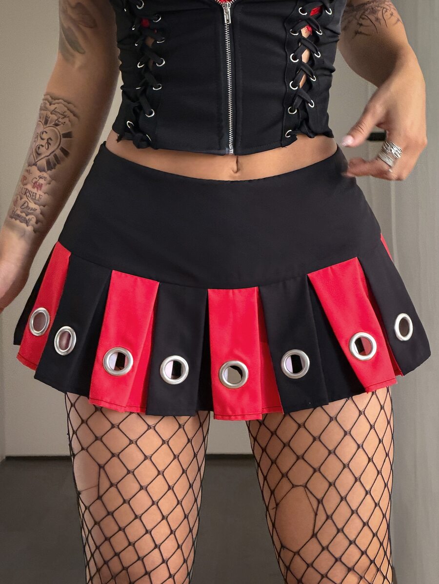 Black pleated mini skirt with ultra low waist and grommet eyelet detailing for women.