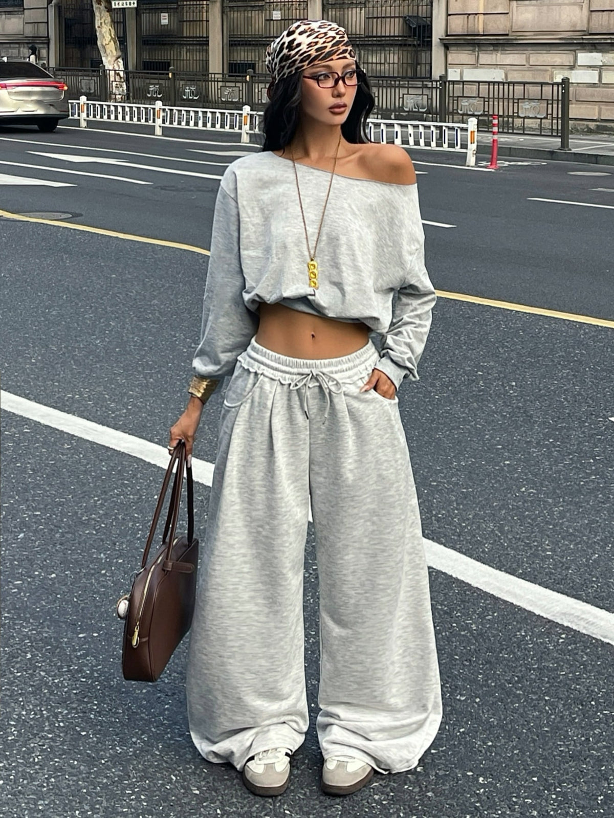 Women's casual straight leg baggy lounge pants in light grey with an adjustable drawstring waist and side pockets.