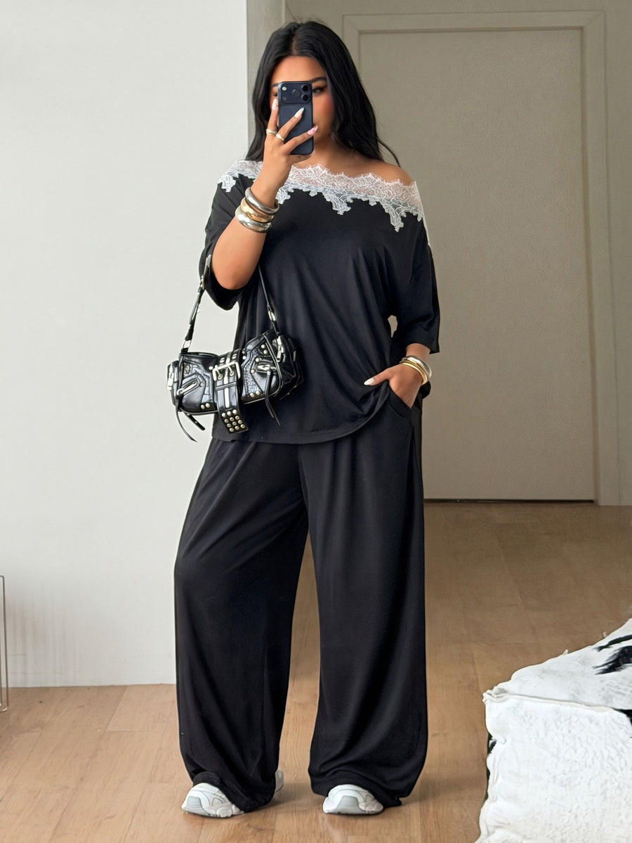 Women's casual two-piece outfit featuring a loose short-sleeve asymmetrical neck t-shirt and matching long wide leg pants with pockets.